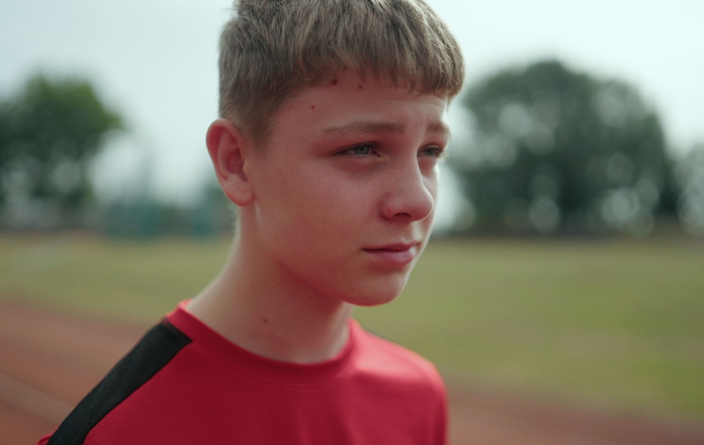 A young boy standing on a race track