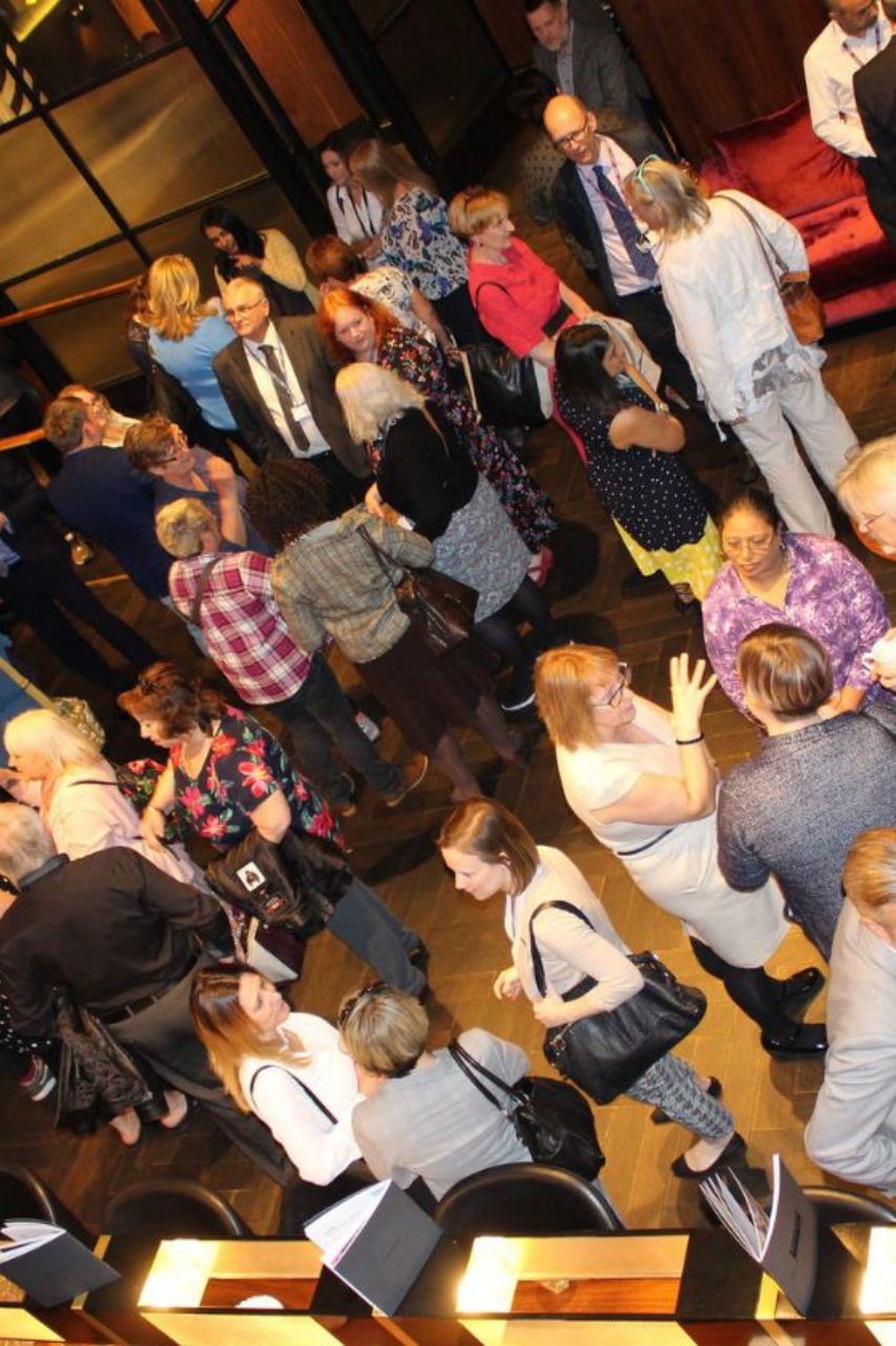 A crowd of people waiting for the film to start